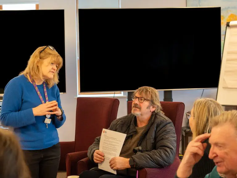 Group of people chatting at a support group meeting