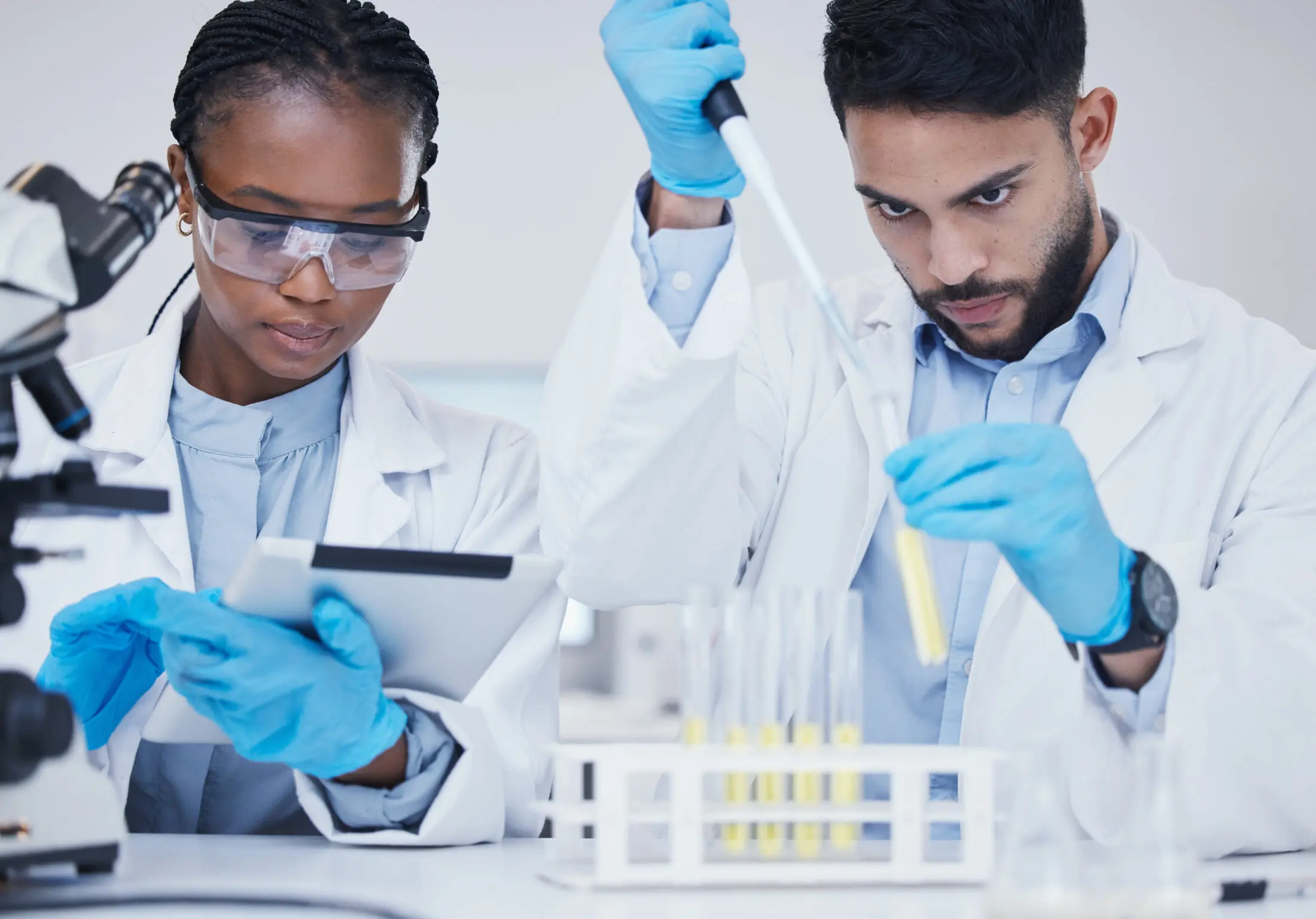 Two scientists with test tubes for research in a laboratory