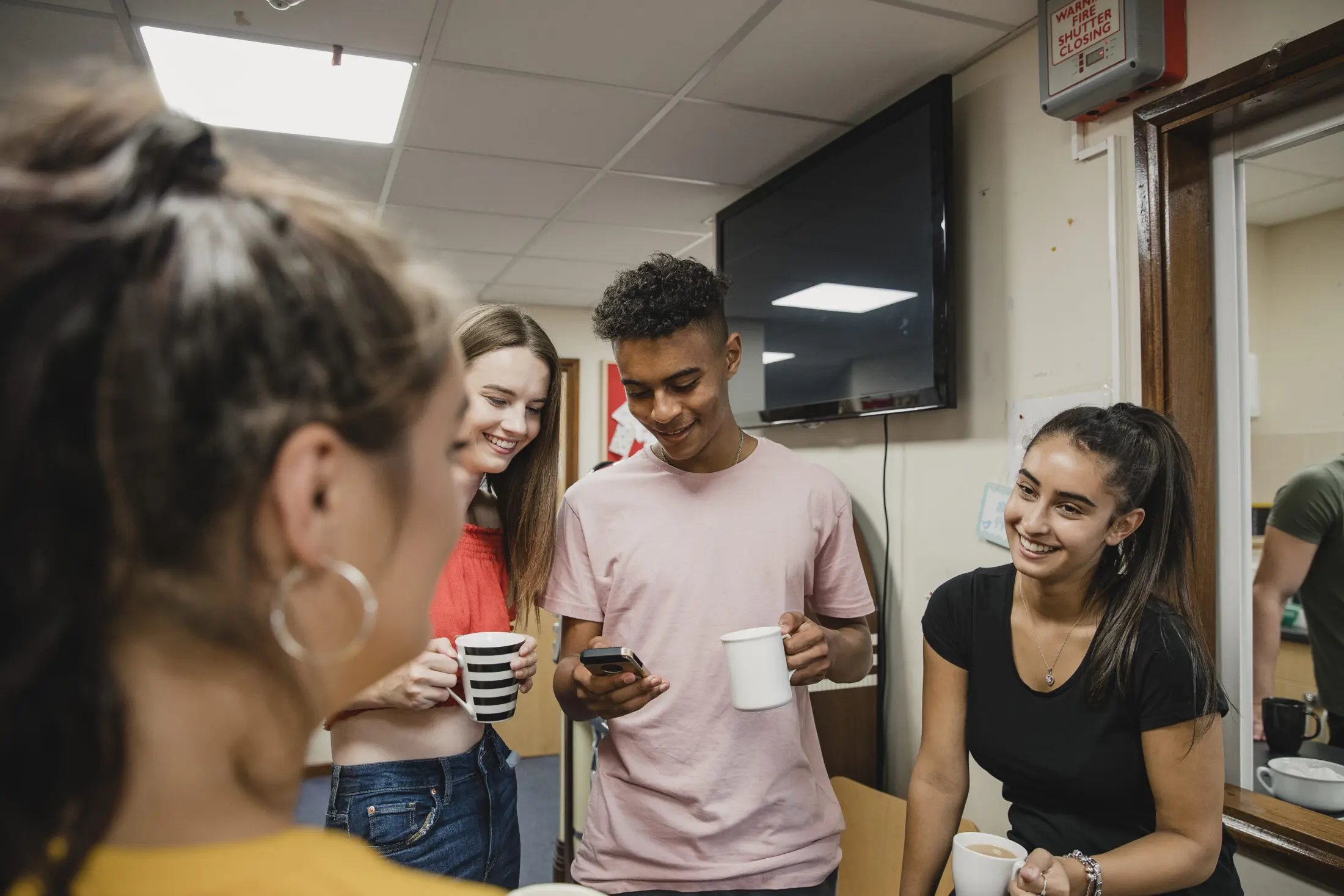 A group of teenagers relaxed and chatting together 
