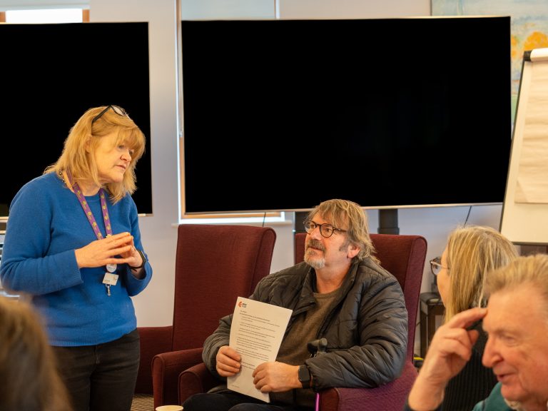 Group of people chatting at a support group meeting
